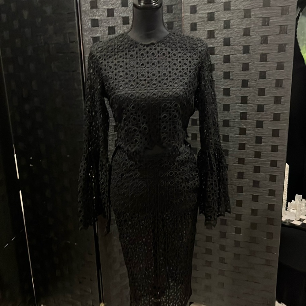 2 -piece skirt set with eyelet detail and flared sleeves.